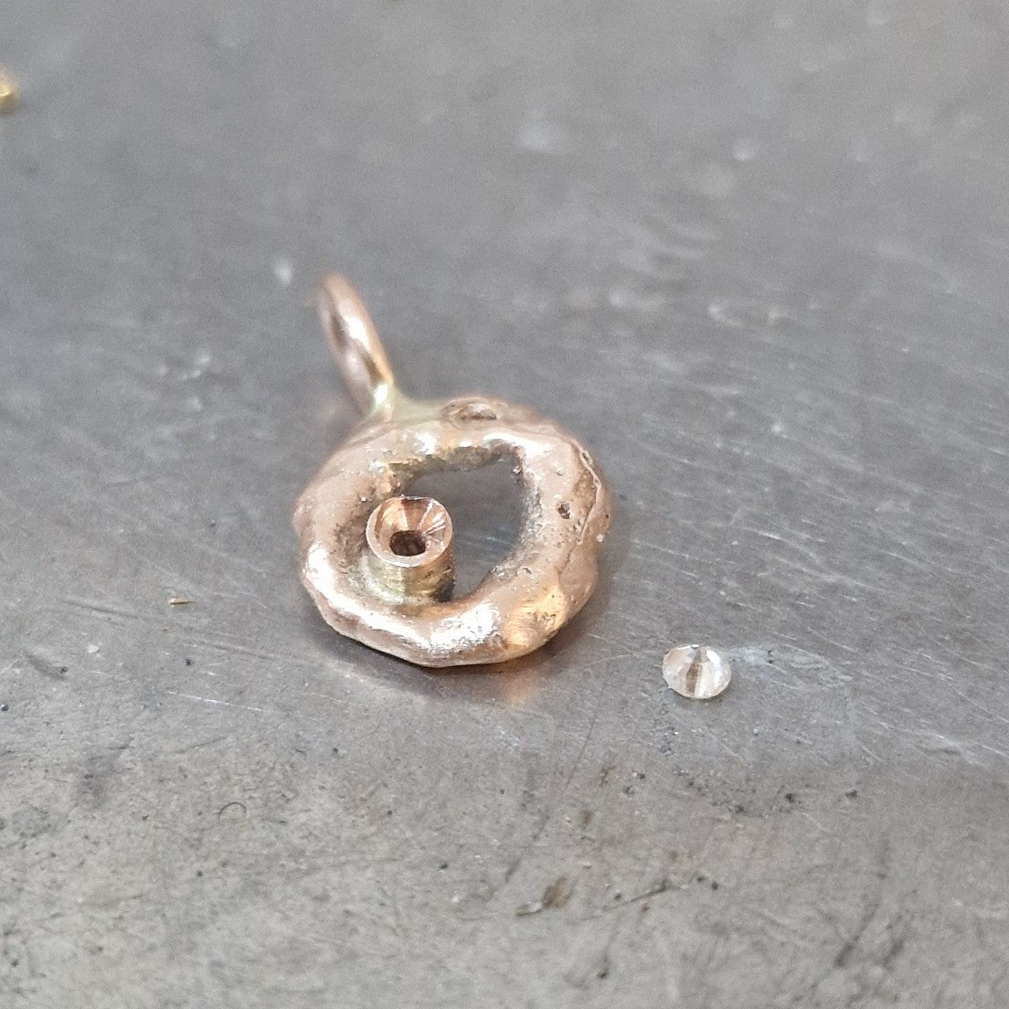 Progress shot of our customers Rose Gold Molten Circle Pendant with the un-set diamond ready to be set, at Golden Snowdrop the jewellers in Shaftesbury near Broad Chalke. 