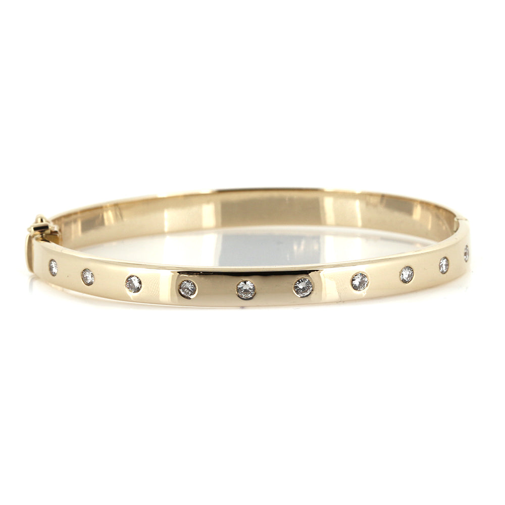 Bespoke Diamond and 9ct Gold Hinged Bangle using our customers Diamonds. Made and designed to our customers specifications at Golden Snowdrop, the jewellers in Shaftesbury near Wilton. 