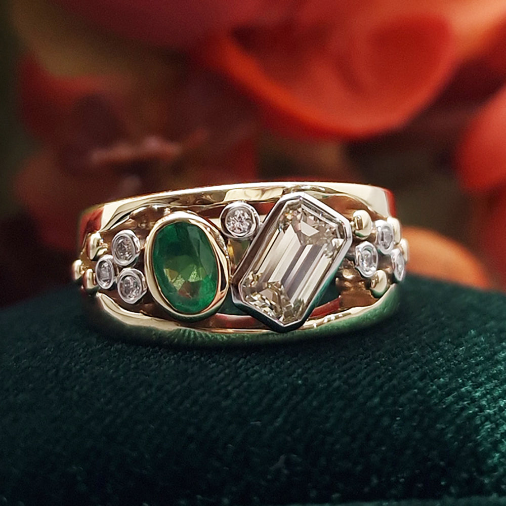 Bespoke Diamond and Emerald Ring set in a 9ct Yellow Gold and Platinum. 
Bespoke design that was remodelled from our customers old rings. The Diamonds and Emerald are showcased within the bespoke ring, at Golden Snowdrop Jewellers in Shaftesbury Dorset,  near Sturminster Newton. 