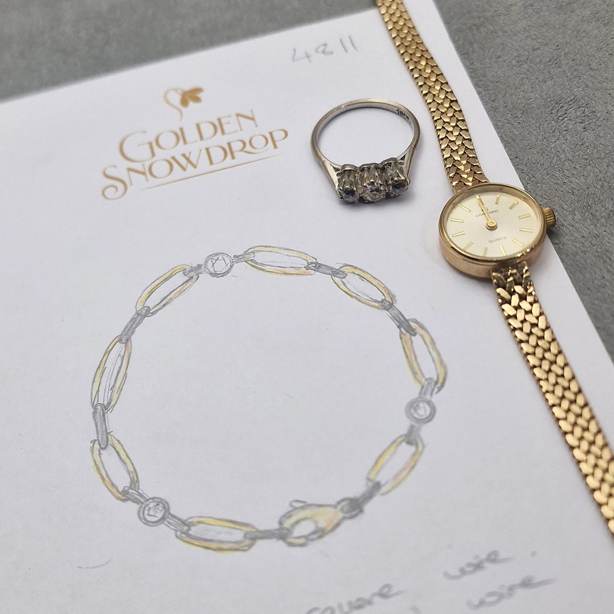 A gold link bracelet with diamond accents is sketched by 'Golden Snowdrop' jewellers. Customers gold to be remodelled. Shaftesbury Dorset