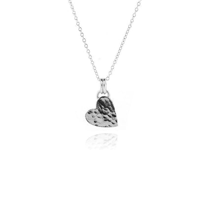 Close detail of sterling silver hammered heart necklace | Golden Snowdrop