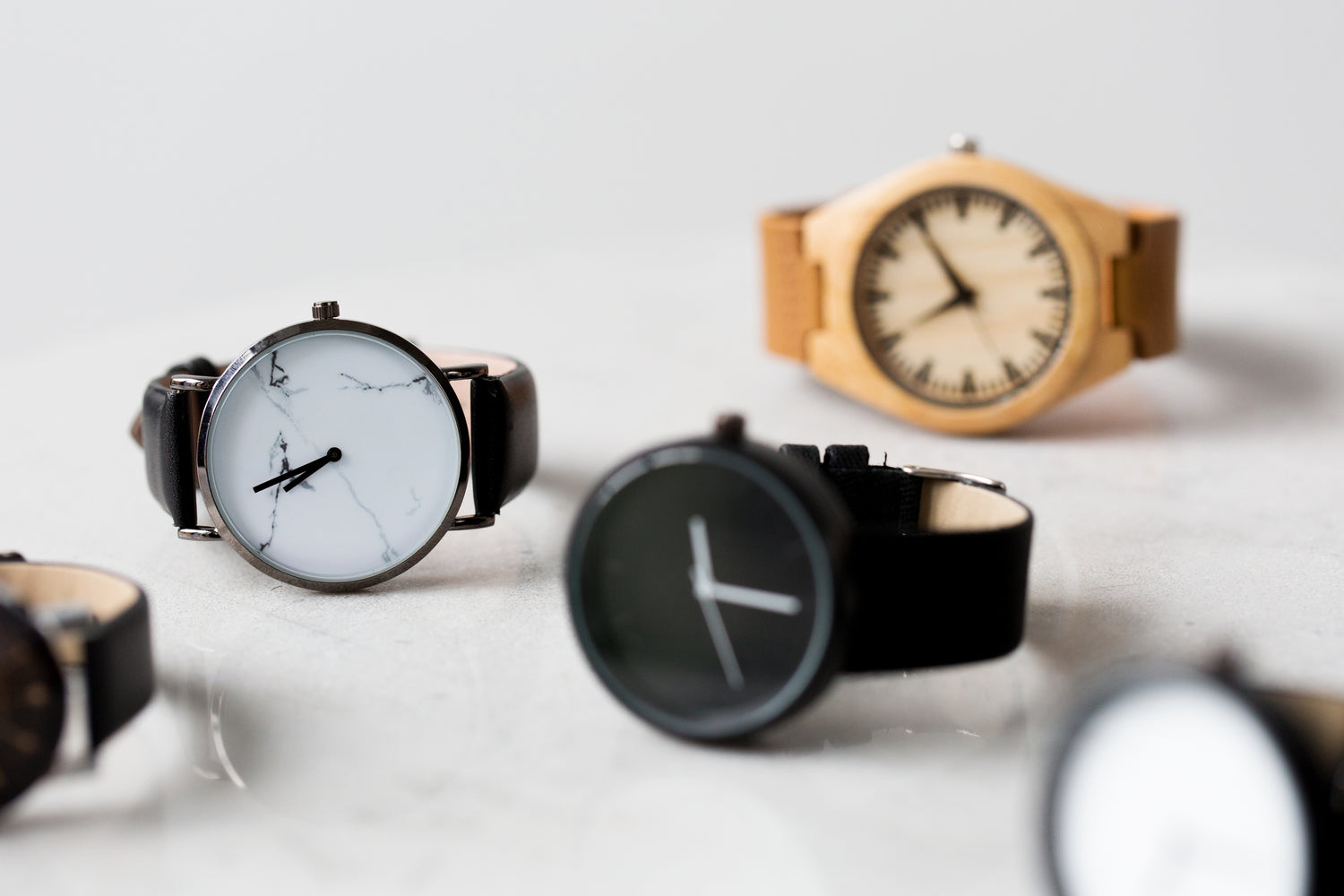 5 modern watches on a grey background