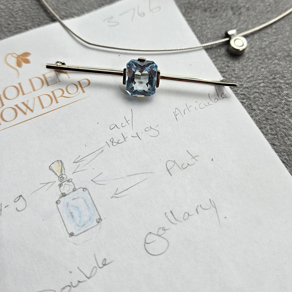 Hand drawn design, by our jeweller, designer and gemologist Stephanie of the Aquamarine, Diamond and 9ct Yellow Gold Pendant with a 9ct White Gold Setting. Remodelled using our customers 9ct, Aquarmarine Bar Brooch and White Gold Diamond Solitaire necklace. Made at Golden Snowdrop the jewellers in Shaftesbury, near Salisbury. 
