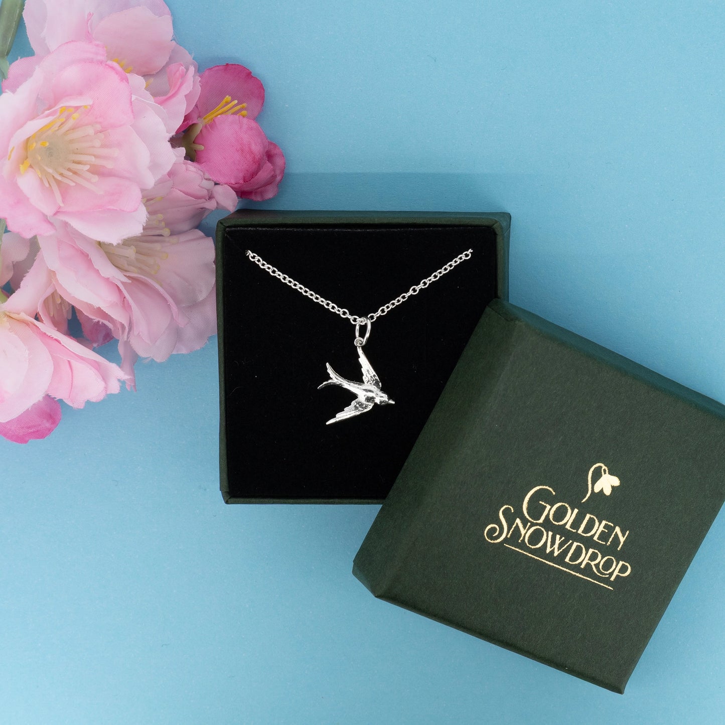 Small swallow pendant necklace in sterling silver displayed in jewellery box | Golden Snowdrop