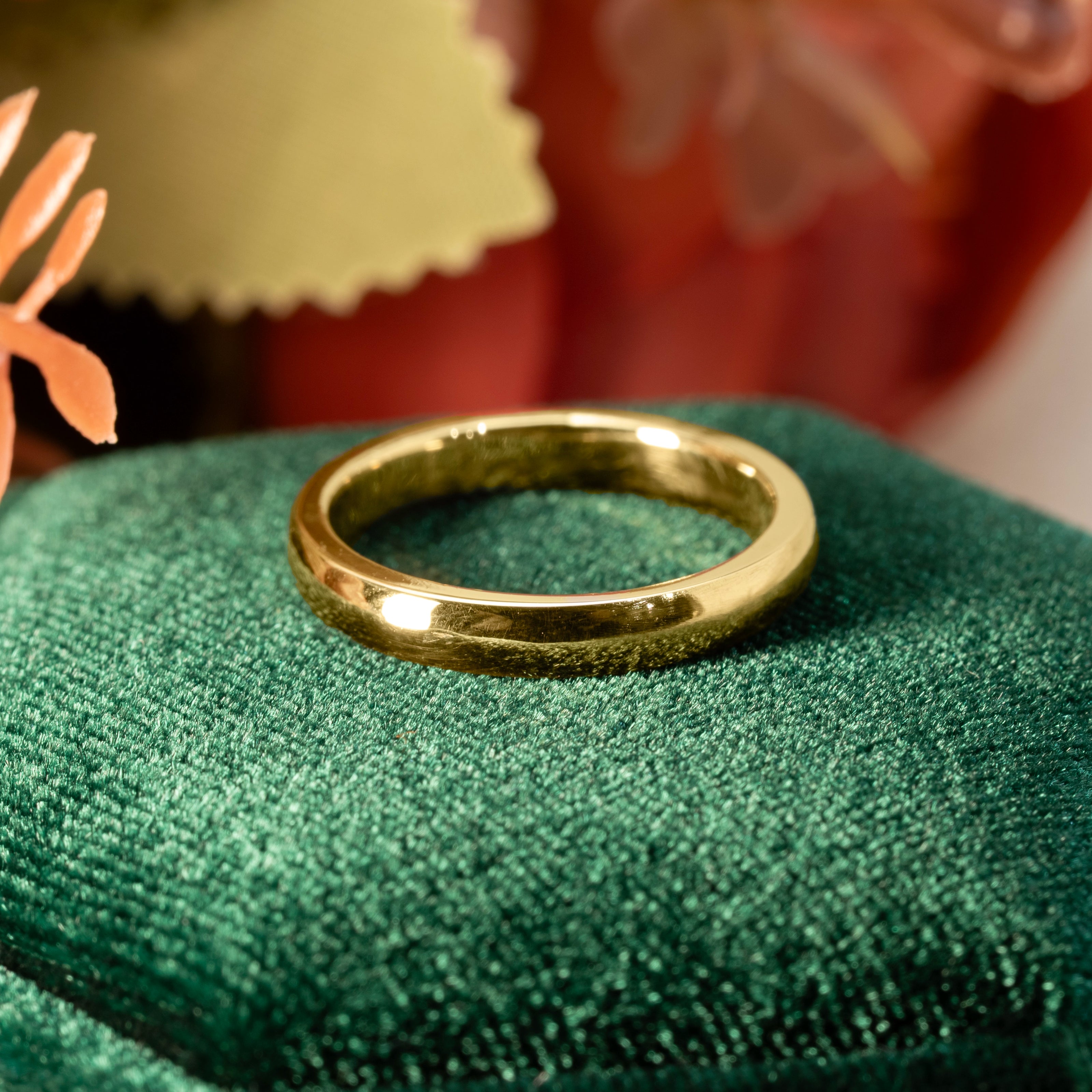 Gold ring on a green cushion with a blurred background  | Golden Snowdrop