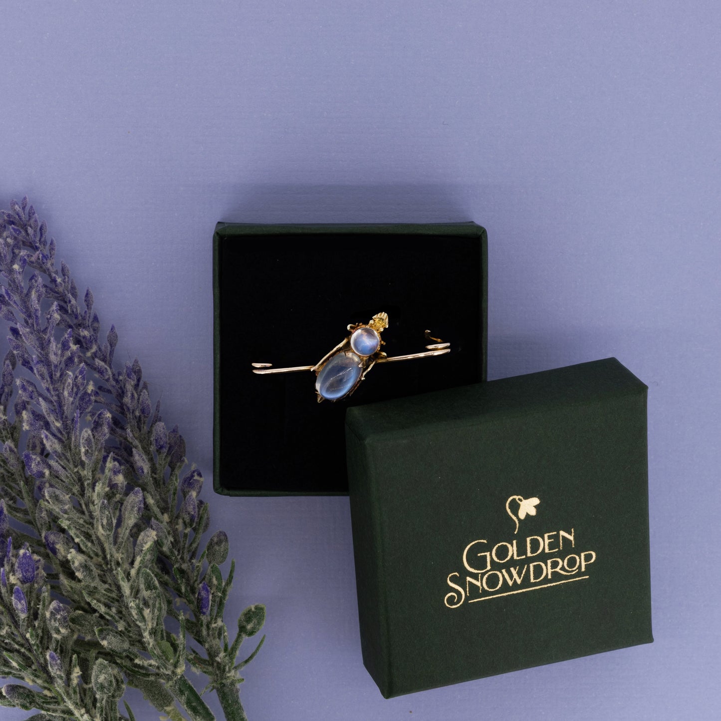 Victorian 15ct yellow gold moonstone brooch displayed in green jewellery box | Golden Snowdrop