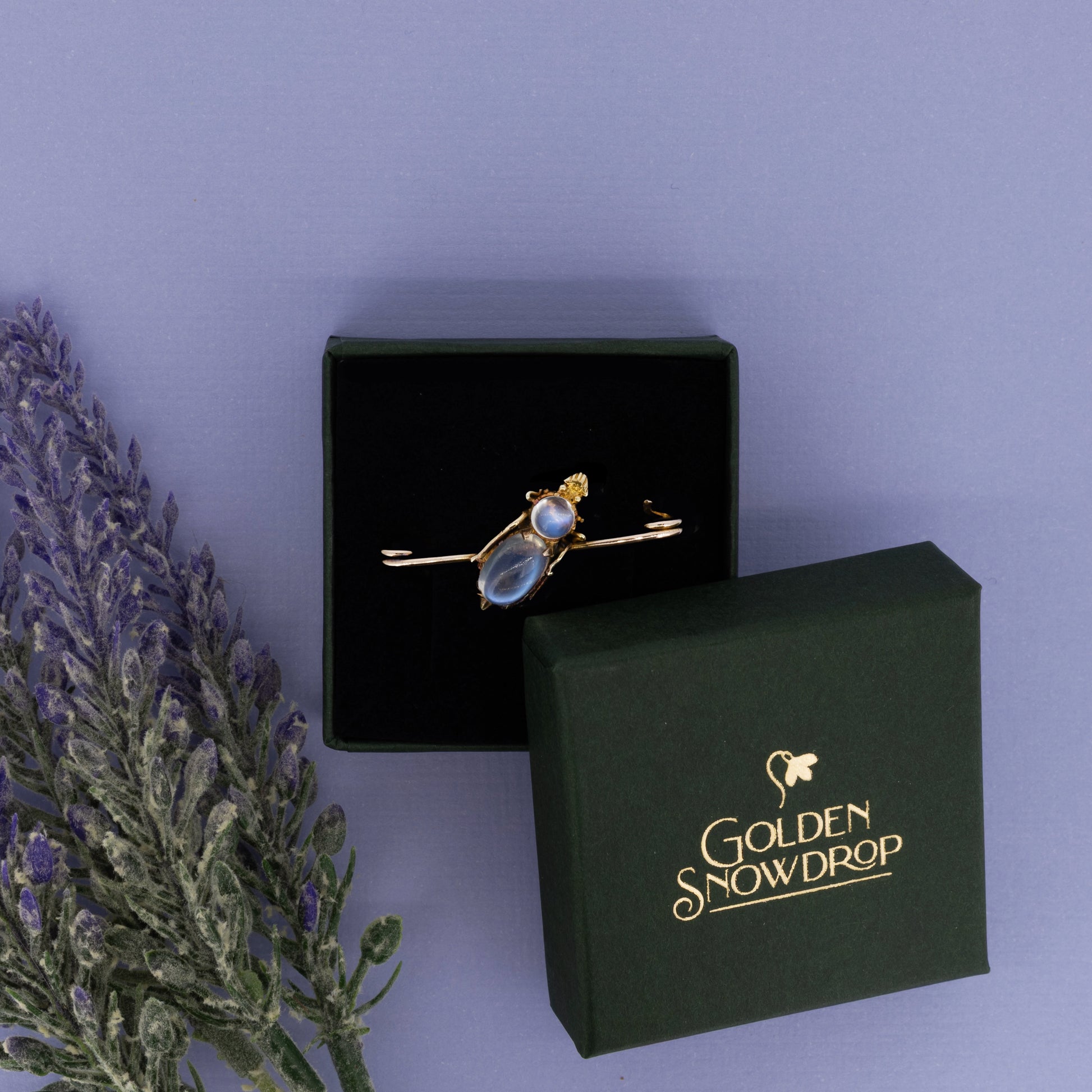 Victorian 15ct yellow gold moonstone brooch displayed in green jewellery box | Golden Snowdrop