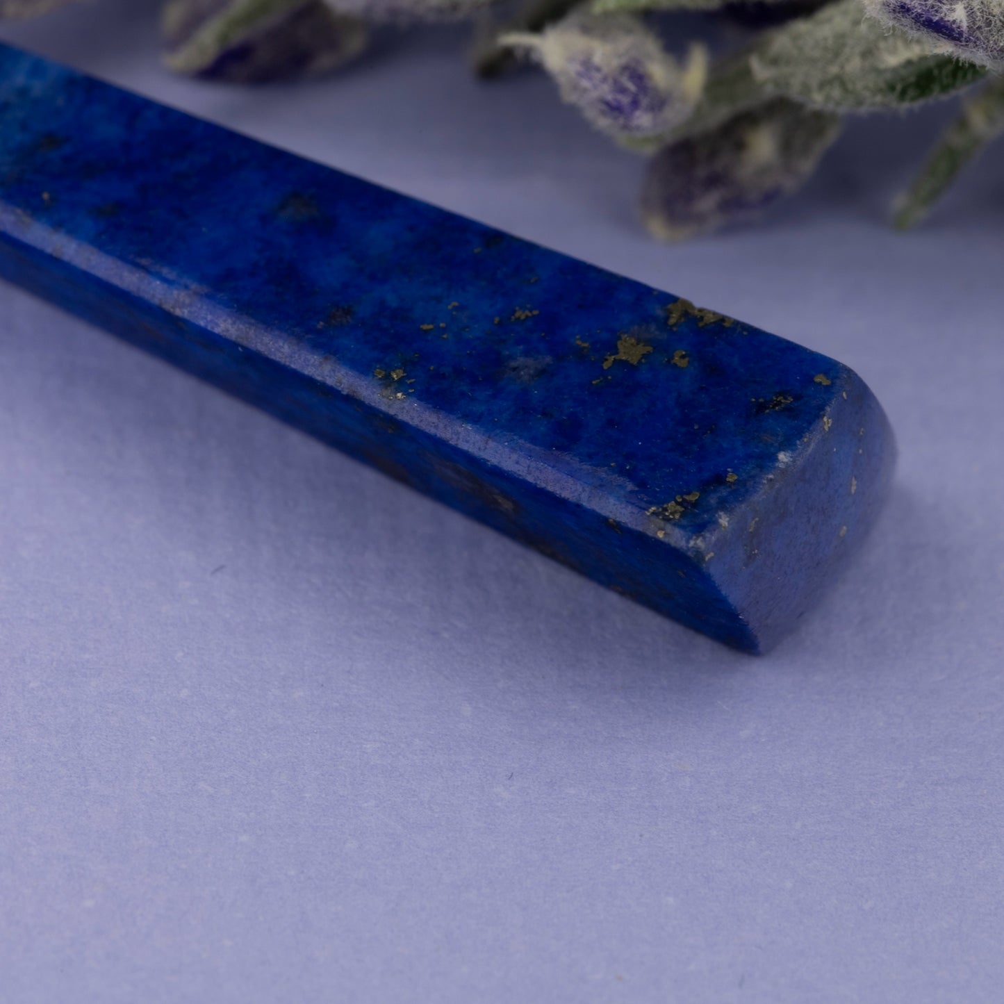 Close up of lapis lazuli long drop earring showing natural stone texture and gold fitting | Golden Snowdrop