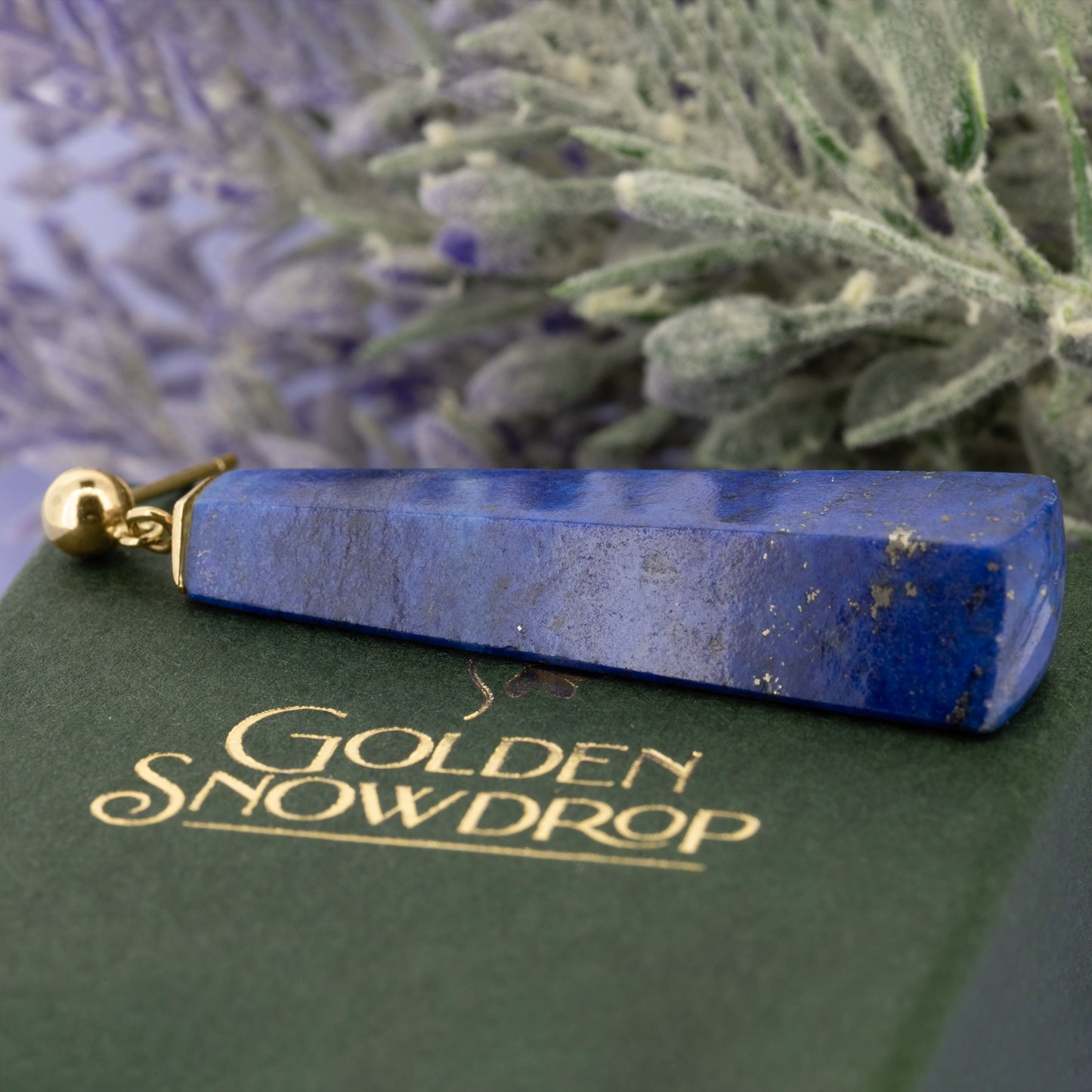 Close up of lapis lazuli drop earring showing polished surface and natural inclusions | Golden Snowdrop