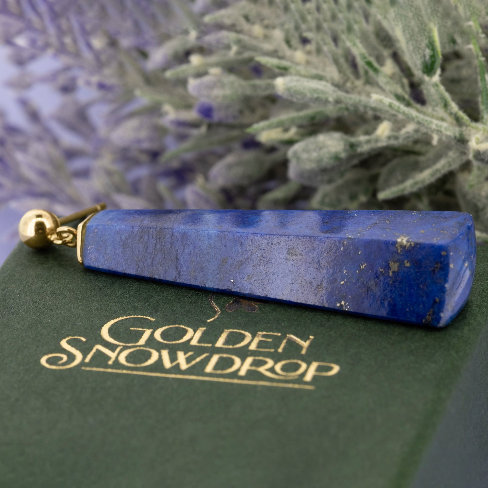 Close up of lapis lazuli drop earring showing polished surface and natural inclusions | Golden Snowdrop