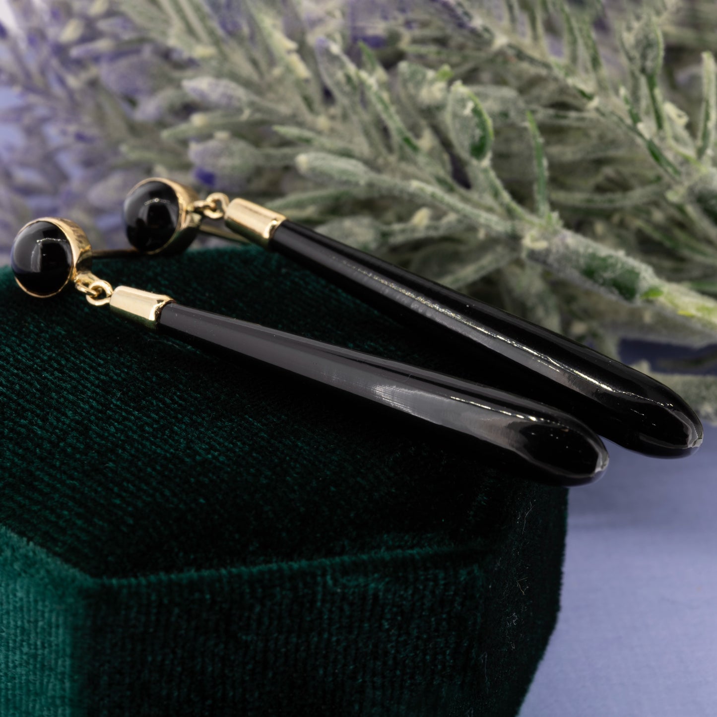 Black onyx torpedo drop earrings showing tapered shape and smooth surface | Golden Snowdrop