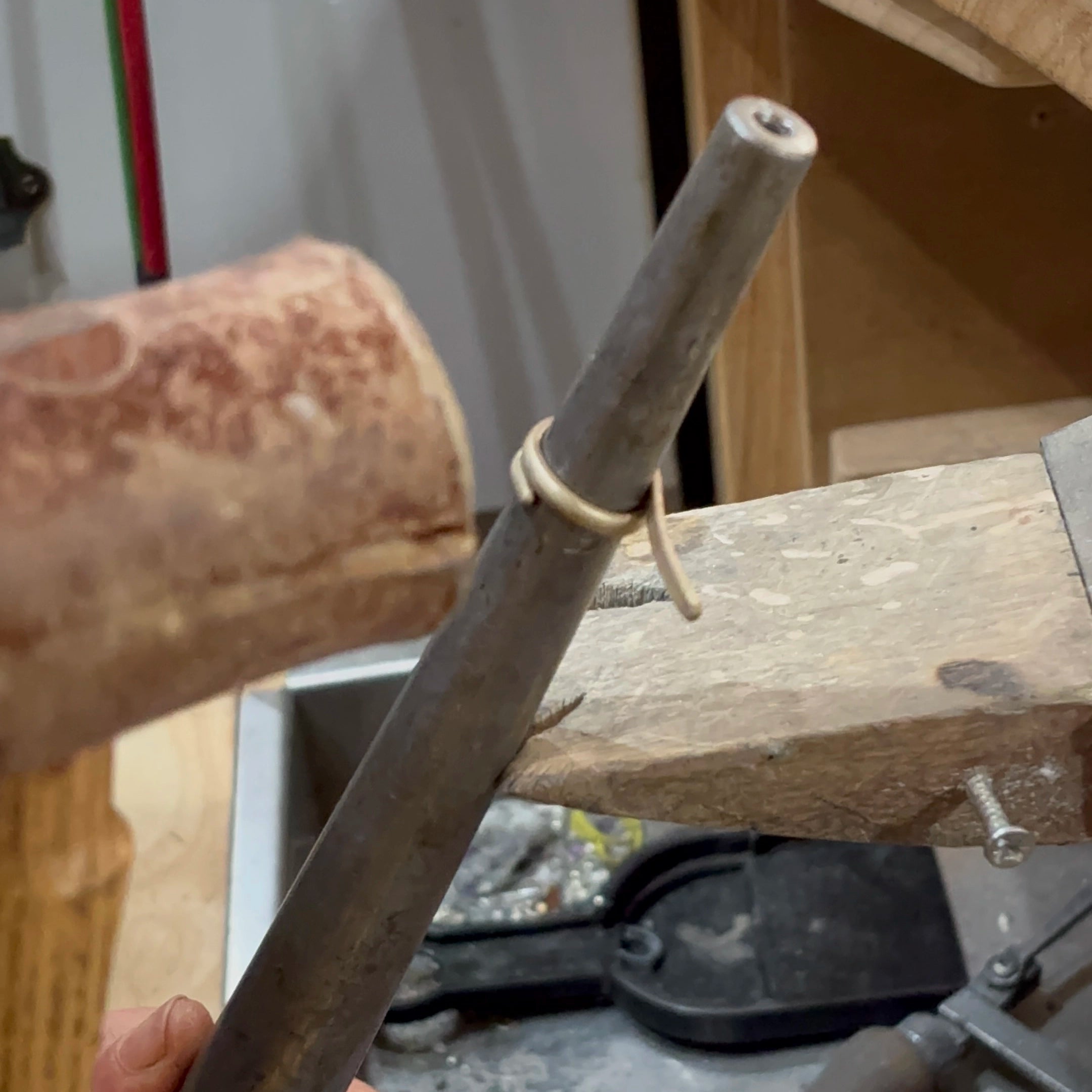 working a gold ring into shape with a hammer  | Golden Snowdrop